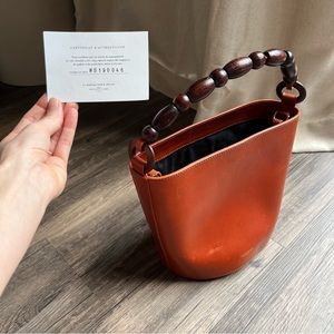 Authenticated Sézane genuine leather bucket bag with wooden beaded handle